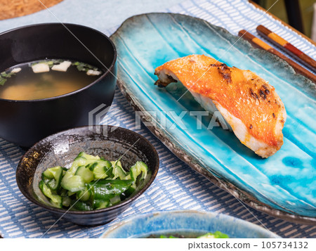 A fillet of alfonsino. A Japanese breakfast scene with miso soup, pickles and grilled fish. A fillet of alfonsino. A Japanese breakfast scene with miso soup, pickles and grilled fish. 105734132