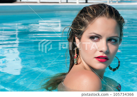 attractive young woman bathing in a pool 105734366
