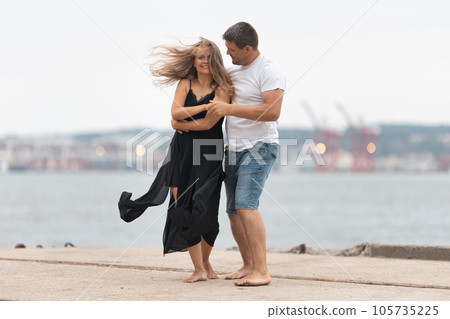 A romantic married couple dancing on the waterfront A romantic married couple dancing on the waterfront 105735225