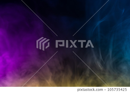 Blurred photo texture of colored smoke on a black background. 105735425