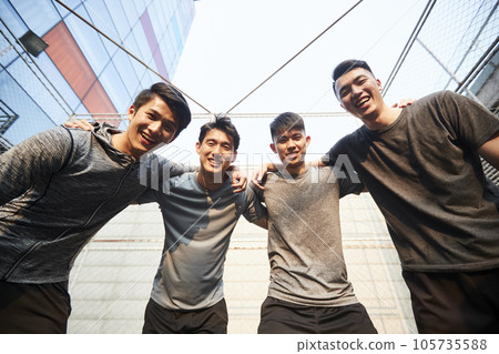 portrait of a team of young asian athletes looking down at camera smiling 105735588