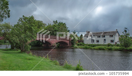 Old Bridge Under Cloudy Sky in Summer Time. Old Bridge in Callander, Scotland, Great Britain. Old Bridge Under Cloudy Sky in Summer Time. Old Bridge in Callander, Scotland, Great Britain. 105735994
