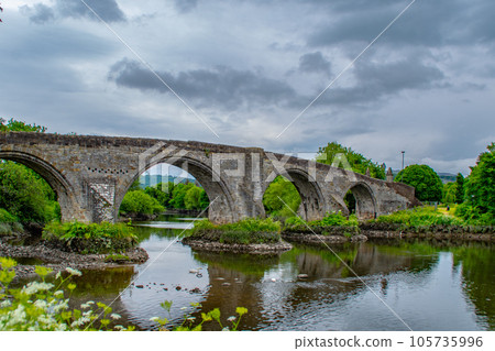 Old Bridge Under Cloudy Sky in Summer Time. Old Bridge in Stirling, Scotland, Great Britain. Old Bridge Under Cloudy Sky in Summer Time. Old Bridge in Stirling, Scotland, Great Britain. 105735996