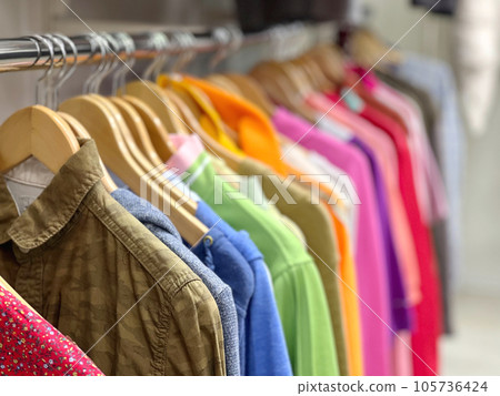 Colorful shirts displayed on hangers 105736424
