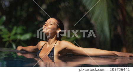 Tropical Paradise, Relaxation of Bikini Girl in Infinity Pool During Vacations Tropical Paradise, Relaxation of Bikini Girl in Infinity Pool During Vacations 105736441