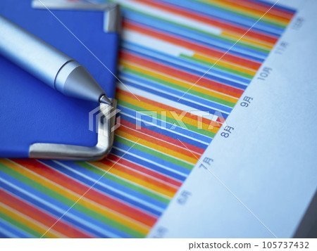 Graphs and blue binders on the table Graphs and blue binders on the table 105737432