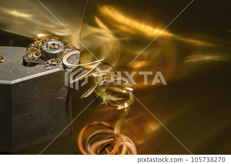 Closeup scene the lathe machine finish cut the brass parts by lathe tools. Closeup scene the lathe machine finish cut the brass parts by lathe tools. 105738270