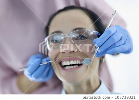 Portrait of woman with her mouth wide open at dentist appointment 105739321