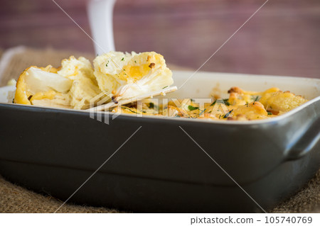 baked cauliflower with chicken fillet and vegetables topped with cheese 105740769