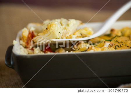 baked cauliflower with chicken fillet and vegetables topped with cheese baked cauliflower with chicken fillet and vegetables topped with cheese 105740770