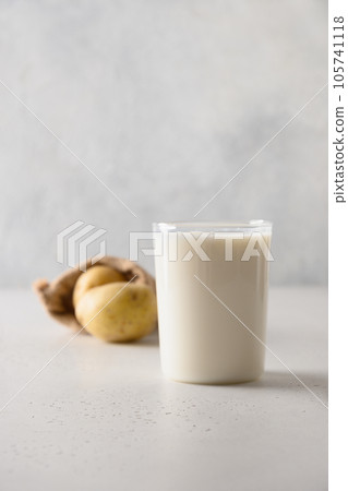 Vegan potato milk in glass, plant based milk replacer. Vegan potato milk in glass, plant based milk replacer. 105741118
