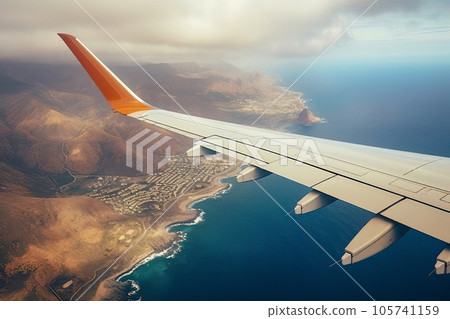 Wing of an airplane flying over a body of water Wing of an airplane flying over a body of water 105741159