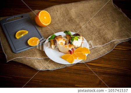 Sweet curd casserole with fruits in a plate Sweet curd casserole with fruits in a plate 105741537
