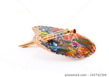 Wooden art palette with brushes isolated on white background. 105742309