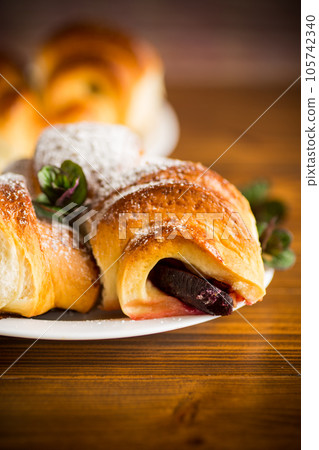baked sweet homemade buns with plum inside 105742340