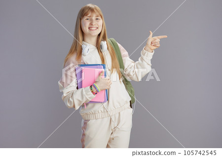 Portrait of happy trendy teenage girl in beige tracksuit Portrait of happy trendy teenage girl in beige tracksuit 105742545
