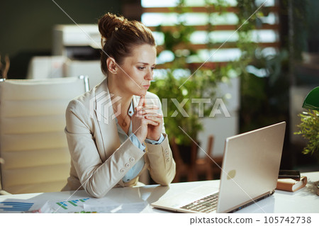 pensive business owner woman in green office 105742738
