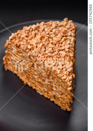Delicious sweet puff waffle cake with cream and nuts cut into pieces Delicious sweet puff waffle cake with cream and nuts cut into pieces 105742988