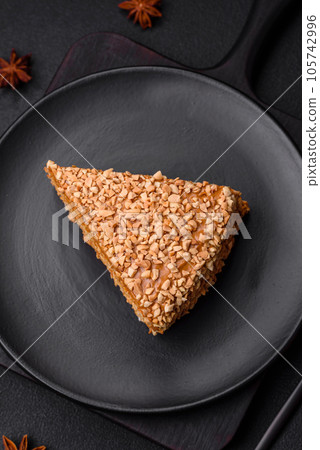 Delicious sweet puff waffle cake with cream and nuts cut into pieces 105742996