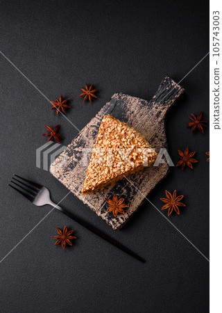 Delicious sweet puff waffle cake with cream and nuts cut into pieces Delicious sweet puff waffle cake with cream and nuts cut into pieces 105743003