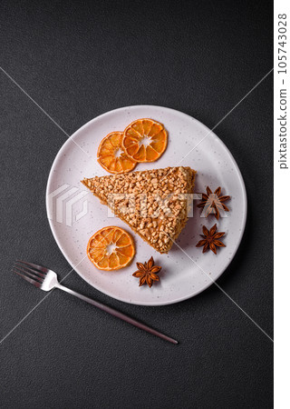 Delicious sweet puff waffle cake with cream and nuts cut into pieces Delicious sweet puff waffle cake with cream and nuts cut into pieces 105743028