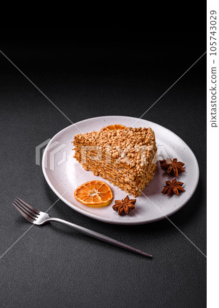 Delicious sweet puff waffle cake with cream and nuts cut into pieces Delicious sweet puff waffle cake with cream and nuts cut into pieces 105743029