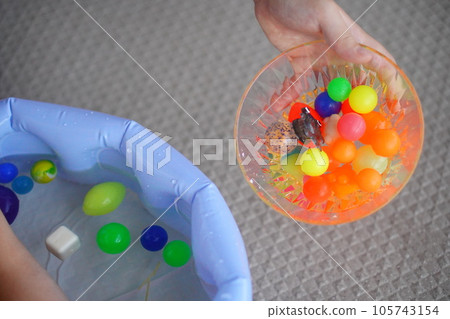 A ball scooped by an elementary school child with a super ball scoop. 105743154