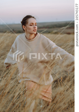 Beautiful model in stylish clothes posing on autumn field. Fashion concept. Lifestyle, recreation. Beautiful model in stylish clothes posing on autumn field. Fashion concept. Lifestyle, recreation. 105743177