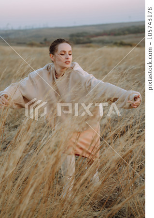 Beautiful model in stylish clothes posing on autumn field. Fashion concept. Lifestyle, recreation. Beautiful model in stylish clothes posing on autumn field. Fashion concept. Lifestyle, recreation. 105743178