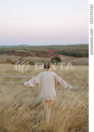Beautiful model in stylish clothes posing on autumn field. Fashion concept. Lifestyle, recreation. Beautiful model in stylish clothes posing on autumn field. Fashion concept. Lifestyle, recreation. 105743182
