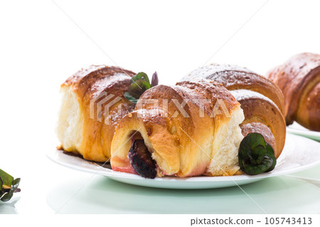 baked sweet homemade buns with plum inside 105743413