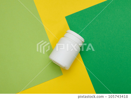 White plastic jar for pills, cream and medicines on a green background. Container for substances, top view 105743418