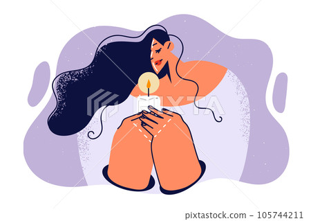 Praying woman holds burning candle as she performs religious ritual after death of close friend 105744211