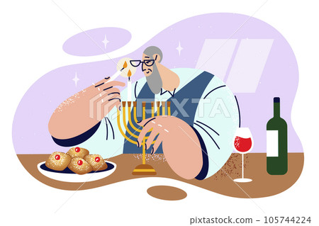 Elderly jewish man lights candles in minor before dinner and prepares to celebrate Hanukkah or Purim Elderly jewish man lights candles in minor before dinner and prepares to celebrate Hanukkah or Purim 105744224