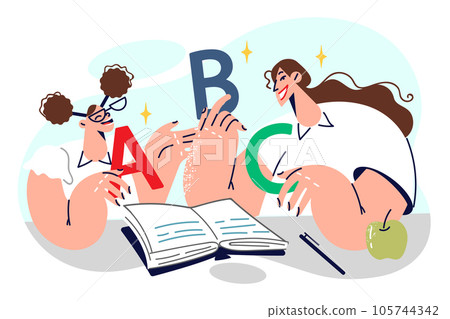 Schoolgirl learns alphabet together with elementary school teacher, sitting in classroom Schoolgirl learns alphabet together with elementary school teacher, sitting in classroom 105744342