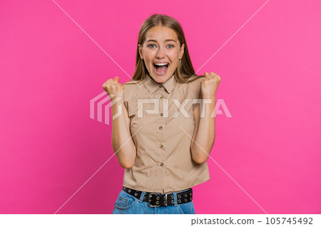 Happy young woman celebrating success, winning, birthday, lottery jackpot goal achievemen, good news 105745492