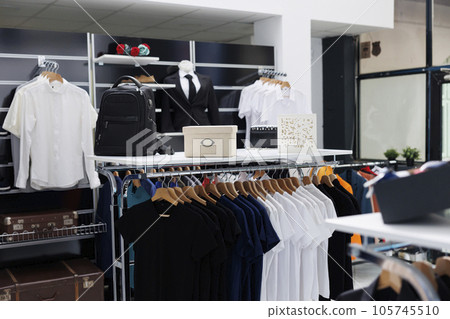 Empty modern boutique filled with formal wear design, retail shop with fashionable clothes on hangers and racks. Clothing store equipped with trendy accessories in shopping center. Fashion concept 105745510