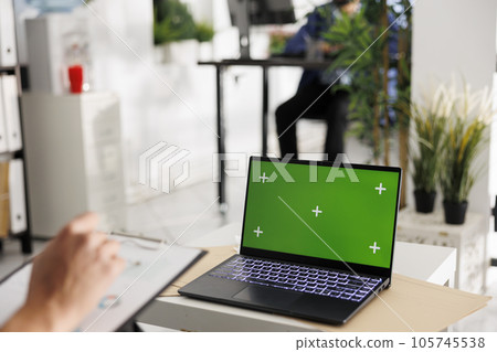 Executive manager planning company budget and using laptop with chroma key screen. Entrepreneur analyzing sales metrics and working on portable computer with green display Executive manager planning company budget and using laptop with chroma key screen. Entrepreneur analyzing sales metrics and working on portable computer with green display 105745538