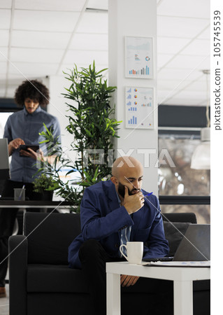 Entrepreneur thinking of solution to complex business development problem in office. Start up company arab employee managing strategy and analyzing sales data on laptop in coworking space 105745539