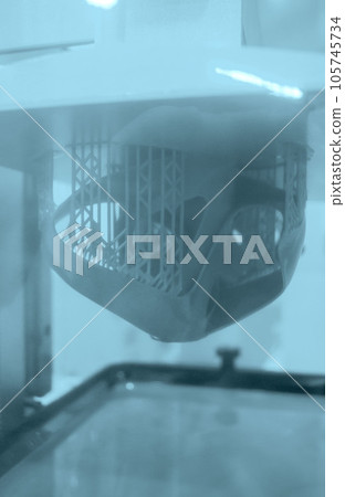 Printed models on 3D printer close-up. Objects printed on photopolymer sla 3D printer from liquid photopolymer resins on printing platform inside 3d printer. Modern progressive additive technology. 105745734