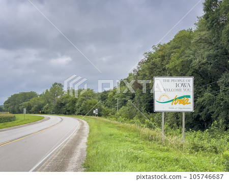 Iowa welcome roadside sign at state border with Nebraska, summer scenery, travel concept Iowa welcome roadside sign at state border with Nebraska, summer scenery, travel concept 105746687
