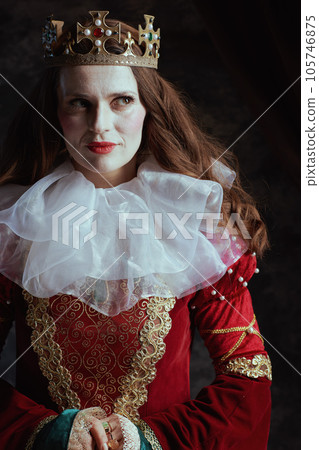 pensive medieval queen in red dress with white collar pensive medieval queen in red dress with white collar 105746875
