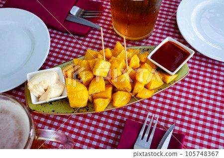Spanish fried spicy potatoes Patatas bravas with sauces Spanish fried spicy potatoes Patatas bravas with sauces 105748367