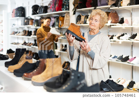 Old and younger women making purchases in shoeshop 105748461