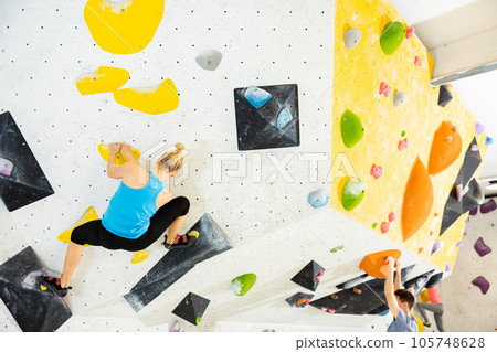 Woman exercising in climbing gym 105748628