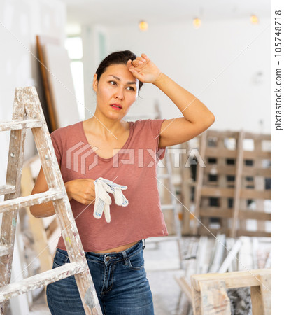 Portrait of tired woman in apartment during repair works 105748718