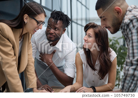 Group of young business people working together while standing in creative office 105749730