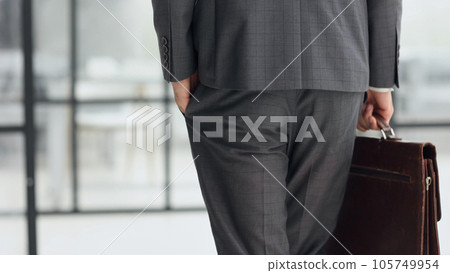 business man with briefcase in office back view business man with briefcase in office back view 105749954