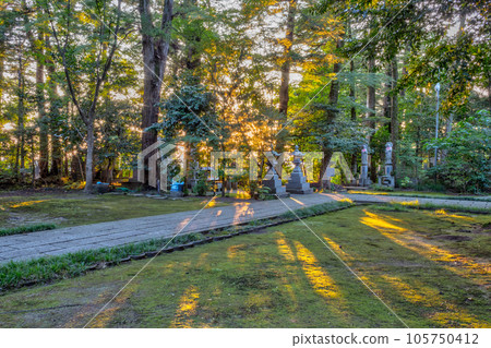 Stone memorials at Daijouji temple, at sunset, Kanazawa, Japan. 105750412