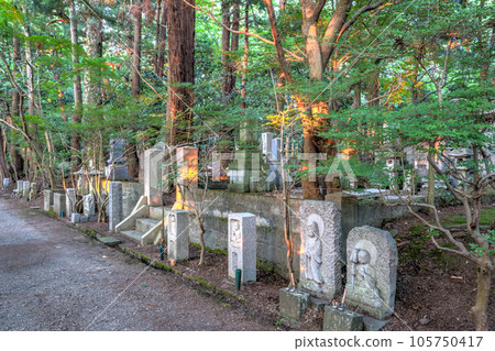 Stone memorials at Daijouji temple, at sunset, Kanazawa, Japan. 105750417
